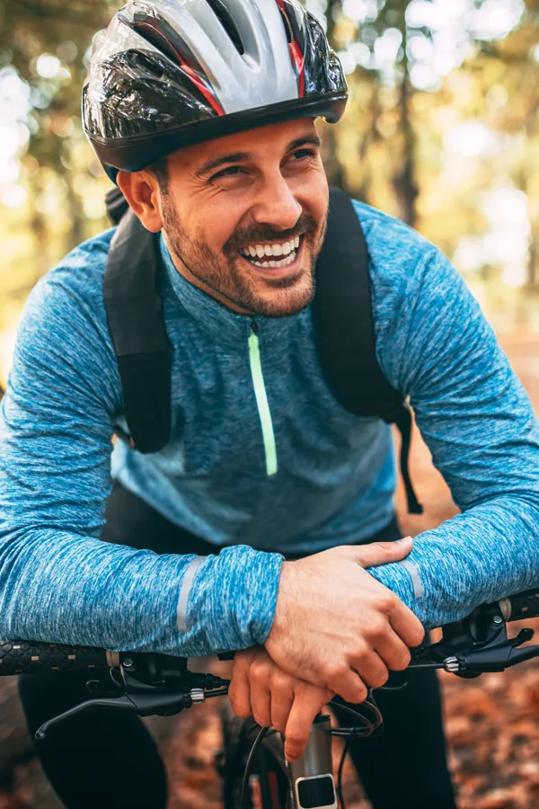 Adrenal-Hormone-Disorder-Treatment A smiling man getting ready for a cycling trip. Get treatment for adrenal hormone disorder from David Garcia, D.O. in Nashville Metro.