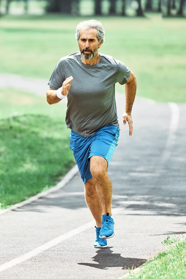 Exosomes-for-Knee-Pain-Treatment A middle-aged man running on a trail. Get exosome therapy for knee pain from David Garcia, D.O. in Nashville Metro.