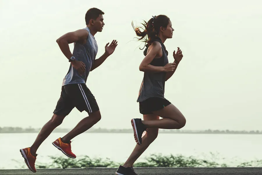 GLP-1-Weight-Loss-Injections-Clinic A couple in profile running along the water. Schedule GLP-1 Weight Loss Injections from David Garcia, D.O. in Nashville Metro.