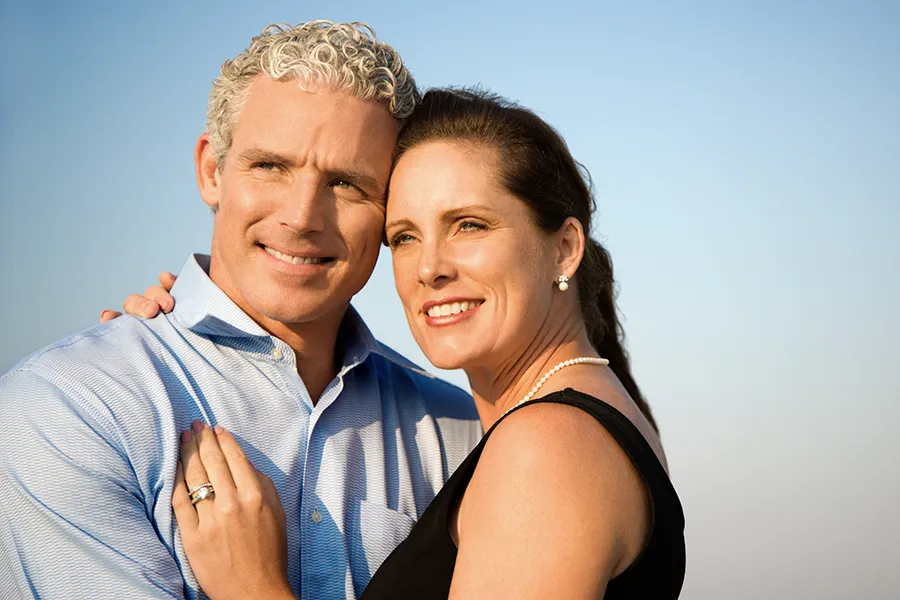 Healthy-Aging-Peptides-Doctor A middle-aged caucasian couple embraces in the sunshine, happy with the healthy aging peptide treatments from David Garcia, D.O. in Nashville Metro
