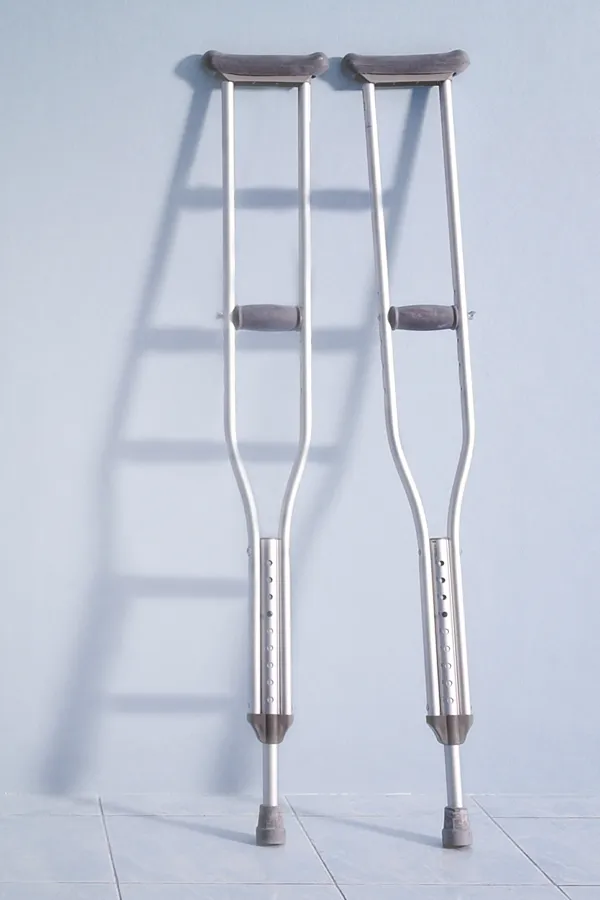 Peptides-for-Healing-and-Recovery-Treatment A pair of crutches rest against a gray wall, representing peptide therapy for healing and recovery from David Garcia, D.O. in Nashville Metro.