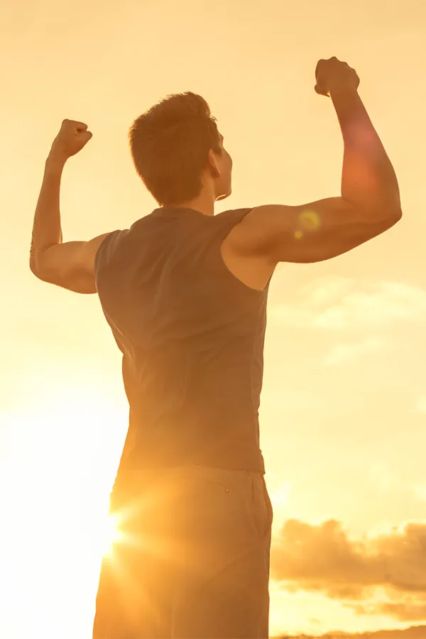 Physician-Guided-Weight-Loss-Treatment A man flexes his arms in the sunrise. Get a consultation about physician-guided weight loss programs from David Garcia, D.O. in Nashville Metro.