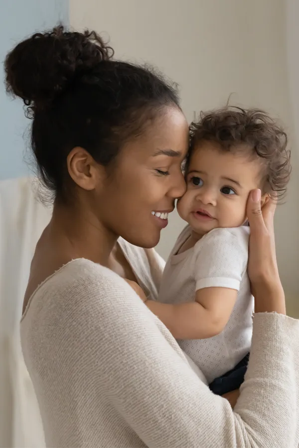 Postpartum-Hormone-Imbalance-Treatment A black woman happily touches her forehead to her infant's head. Get treatment for postpartum hormone imbalance from David Garcia, D.O. in Nashville Metro.