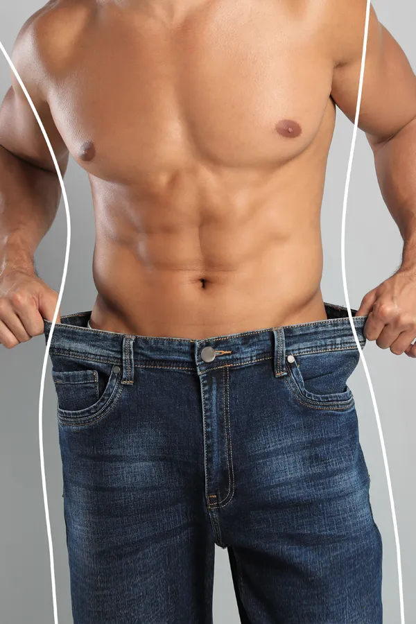 Semaglutide-Weight-Loss-Treatment A strong shirtless man in jeans holds the waistlines of his too-big jeans to show the success of semaglutide weight loss from David Garcia, D.O. in Nashville Metro.