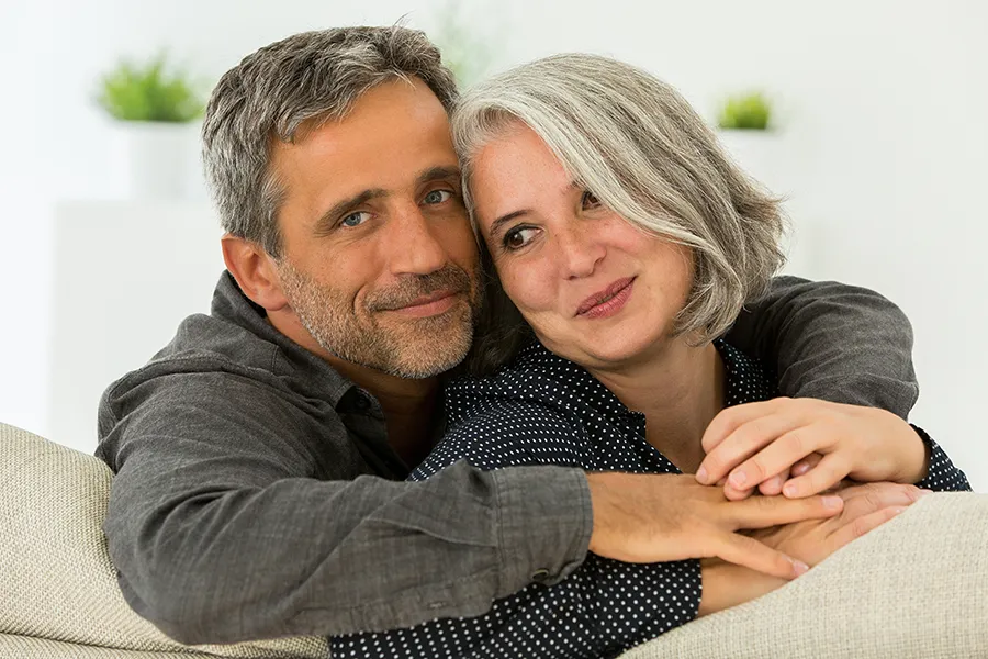 Services-Clinic A middle-aged couple embrace on the couch. Get health and wellness services from David Garcia, D.O. in Nashville Metro.