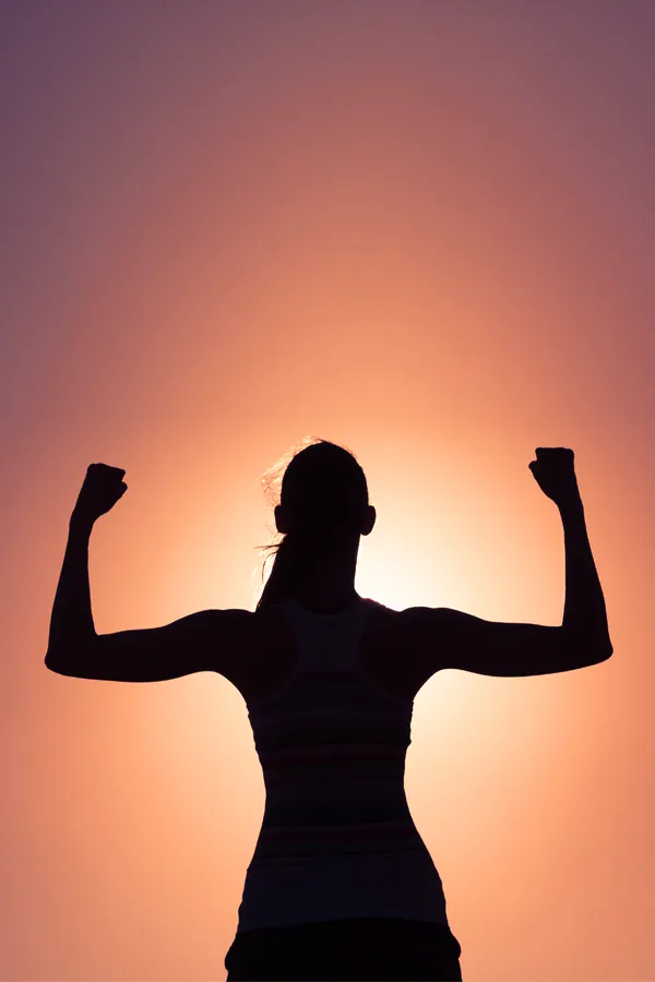 Stem-Cell-IV-Therapy-Treatment A woman silhouetted by the sunset flexes her strong arms. Get Stem Cell IV Therapy from David Garcia, D.O. in Nashville Metro.
