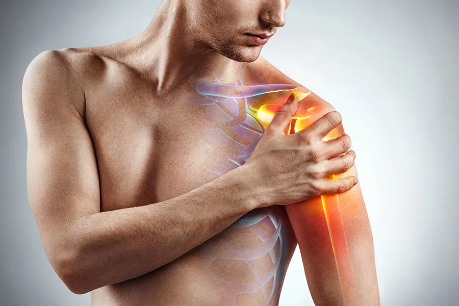 Stem-Cells-for-joint-Pain-Clinic A man holds his shoulder, highlighted in red, in pain. Schedule stem cells for joint pain from David Garcia, D.O. in Nashville Metro.