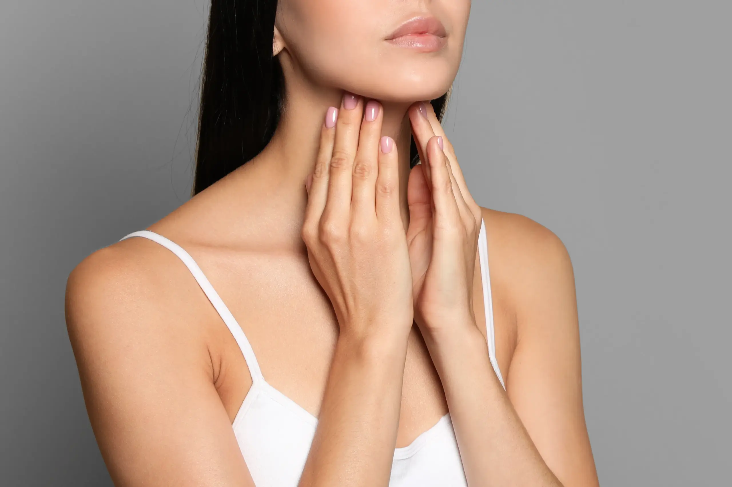 Thyroid-Doctor A woman in a white tank top touches her neck looking for signs of thyroid disorder. Get help for thyroid disorders from David Garcia, D.O. in Nashville Metro.