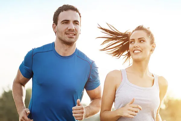Weight-Loss-Resistance-Doctor A couple happily jogging in the sunlight after receiving effective weight loss resistance care from David Garcia, D.O. in Nashville Metro.